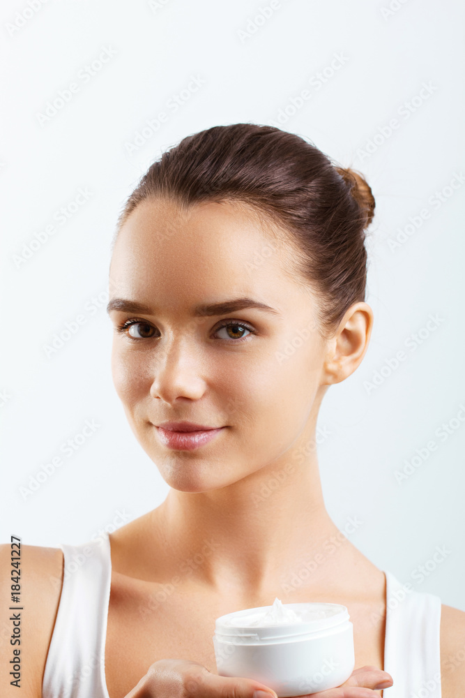 Face Skincare. Woman with healthy smooth facial clean skin holding bottle cream.Beauty face care.Facial treatment.Cosmetology.Beauty and Spa. Face Skincare. Woman with healthy smooth facial clean skin holding bottle cream.Beauty face care.Facial treatment.Cosmetology.Beauty and Spa.