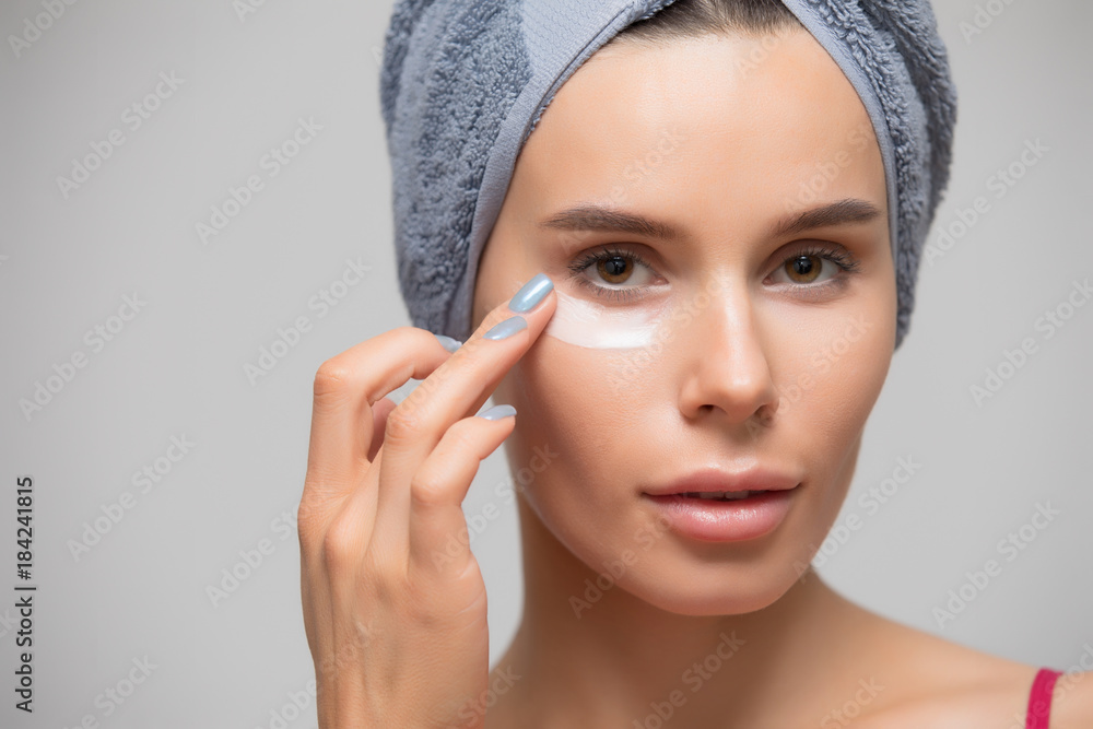 Beauty, woman apply moisturizing cream on skin under eye Beauty, woman apply moisturizing cream on skin under eye