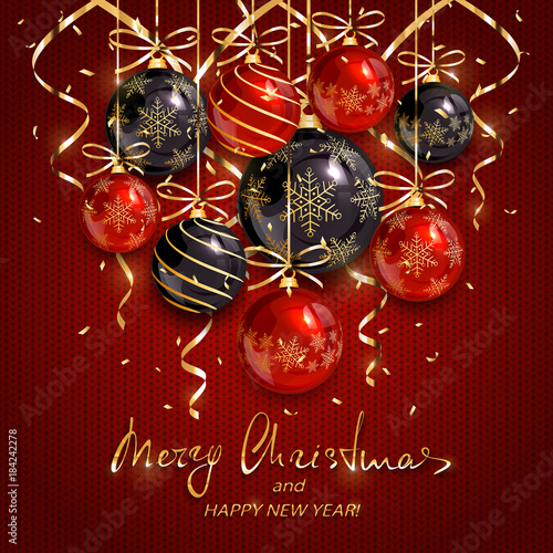 Red and black Christmas balls and golden streamers on knitted background