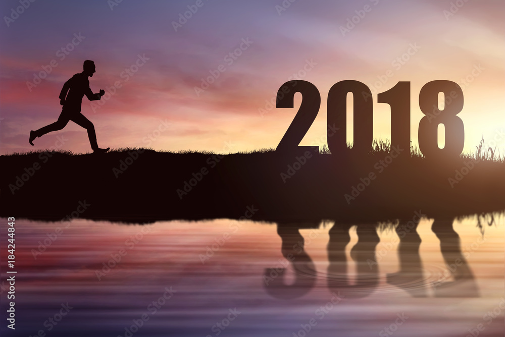 Silhouette of businessman running reaching goal of 2018 Silhouette of businessman running reaching goal of 2018