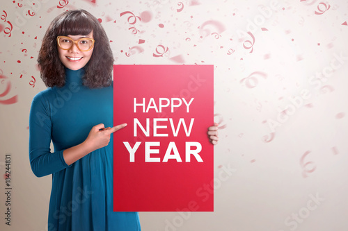 Happy asian woman showing red board with Happy New Year text