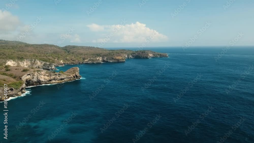 Aerial view of Rocky coast with high cliffs, sea surf with breaking waves on the coast, Bali, Indonesia. Ocean with waves and rocky cliff. 4K video. Travel concept Aerial footage Aerial view of Rocky coast with high cliffs, sea surf with breaking waves on the coast, Bali, Indonesia. Ocean with waves and rocky cliff. 4K video. Travel concept Aerial footage