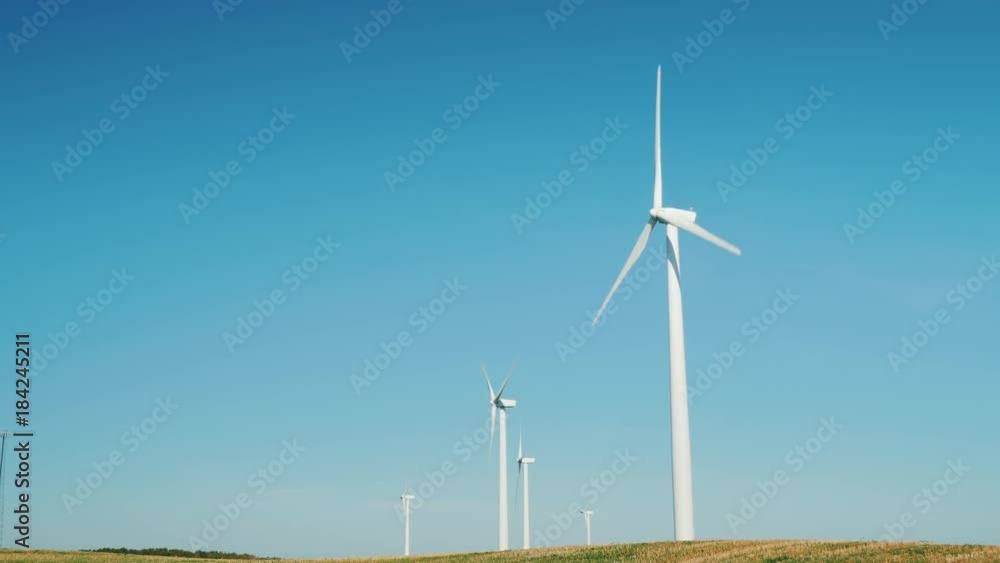 Several wind generators against the blue sky Several wind generators against the blue sky