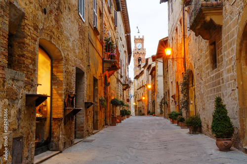 Fototapeta Naklejka Na Ścianę i Meble -  Pienza, Tuscany, Italy - ancient street with stone buildings, on background the city hall bell tower