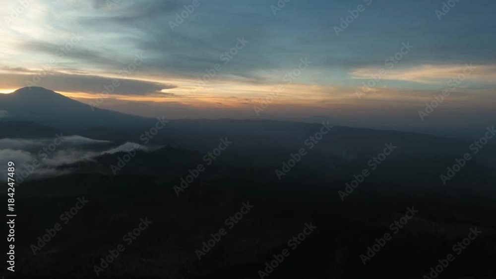 Beautiful sunset in the mountains on Jawa island, Indonesia. Aerial view of mountains landscape under sky with clouds, rainforest. 4K Aerial footage. Beautiful sunset in the mountains on Jawa island, Indonesia. Aerial view of mountains landscape under sky with clouds, rainforest. 4K Aerial footage.