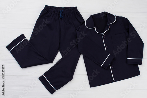 Classic pajama for young boy. Navy shirt and pants decorated with white edging. Simple and elegant.