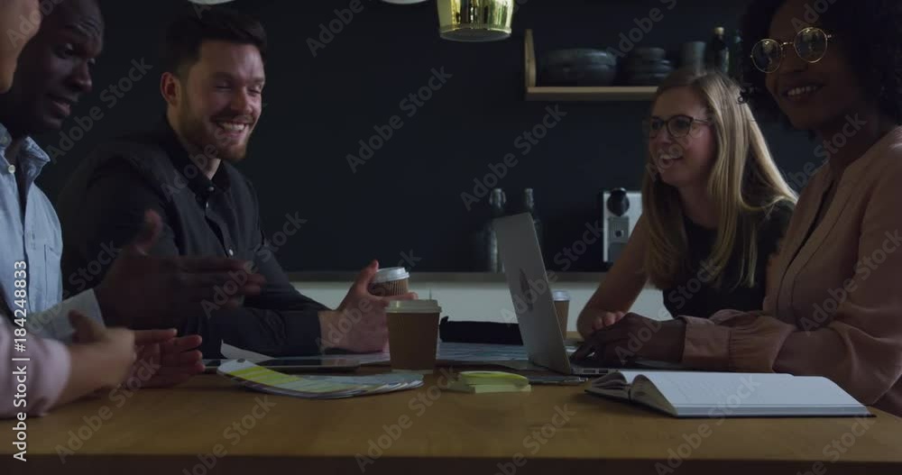 Diverse group of businesspeople talking together in an office meeting Diverse group of businesspeople talking together in an office meeting