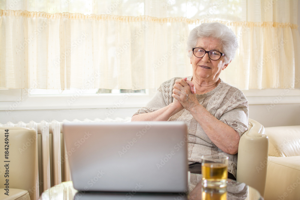 Emotional senior woman having video call with grandchildren via laptop. Emotional senior woman having video call with grandchildren via laptop.