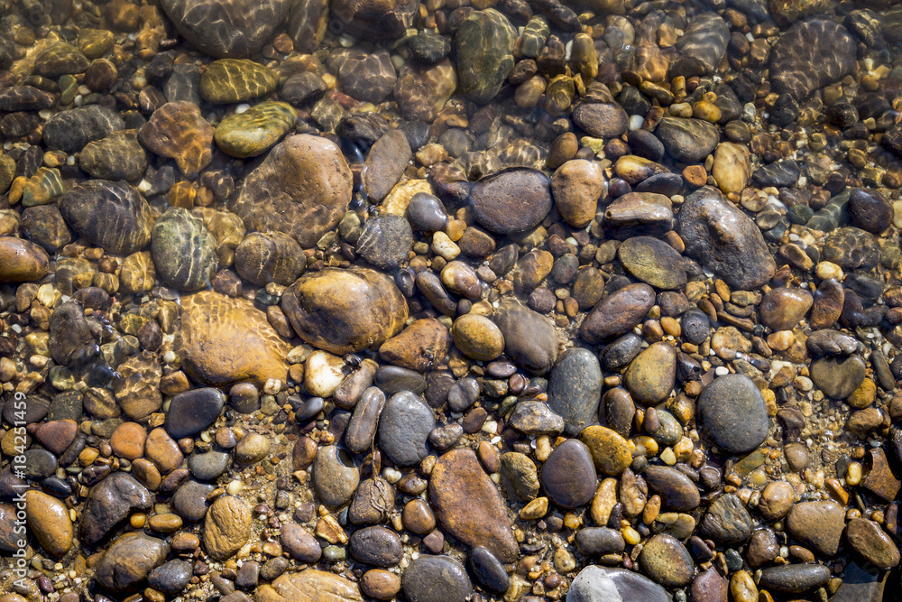 Natural stone on river stone beach, outdoor day light Natural stone on river stone beach, outdoor day light