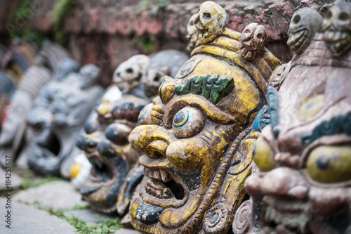 Souvenir masks near wall on Nepalese street market, Kathmandu, Nepal.