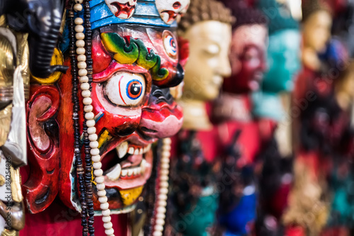 Traditional red Bhairav hindu mask hanging at souvenir market © Ievgen Skrypko