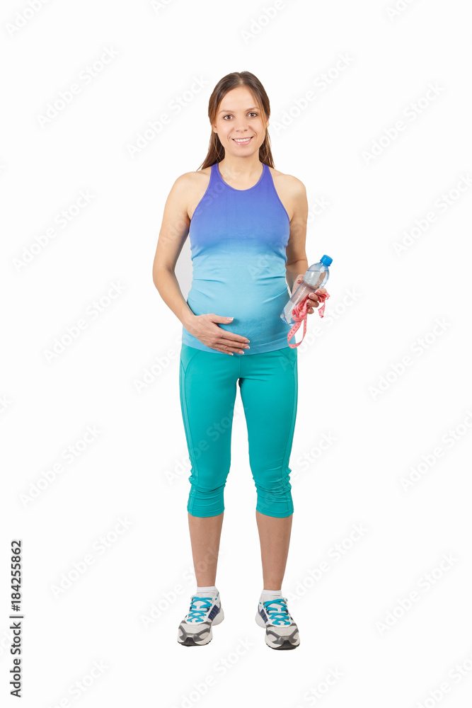 Sporty pregnant woman with a bottle of water and tape measure, isolated Sporty pregnant woman with a bottle of water and tape measure, isolated