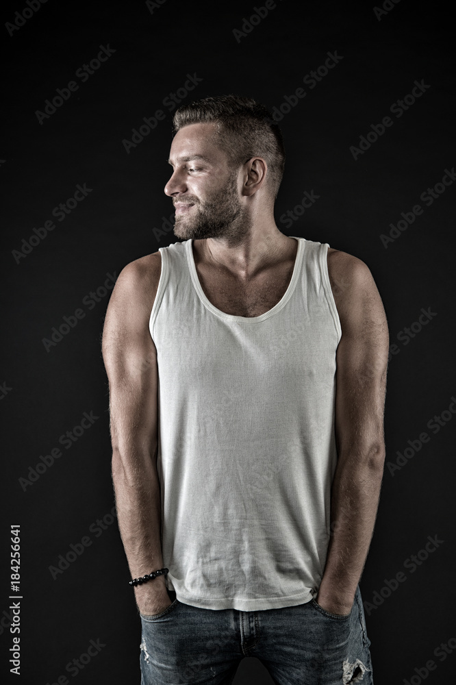 Macho in vest with muscular hands in jeans pockets Macho in vest with muscular hands in jeans pockets