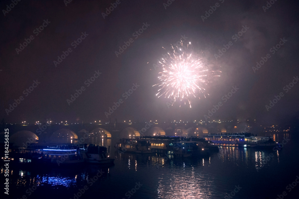 Fireworks on New Year's Eve over ships on the Vltava River in Prague