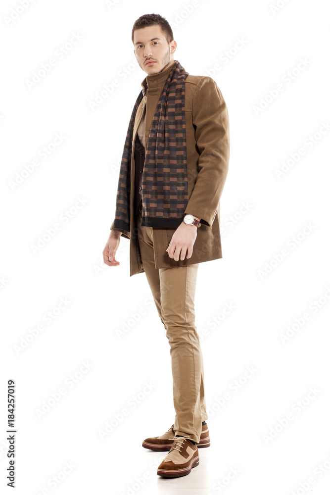 young handsome man in winter clothes with a scarf young handsome man in winter clothes with a scarf