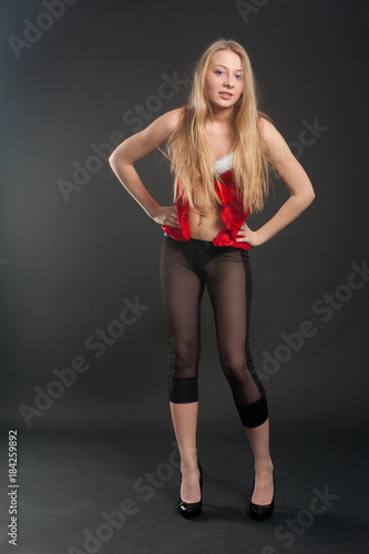 Beautiful sexy blonde female model dressed in a Santa Claus dress. Sensual girl for Christmas