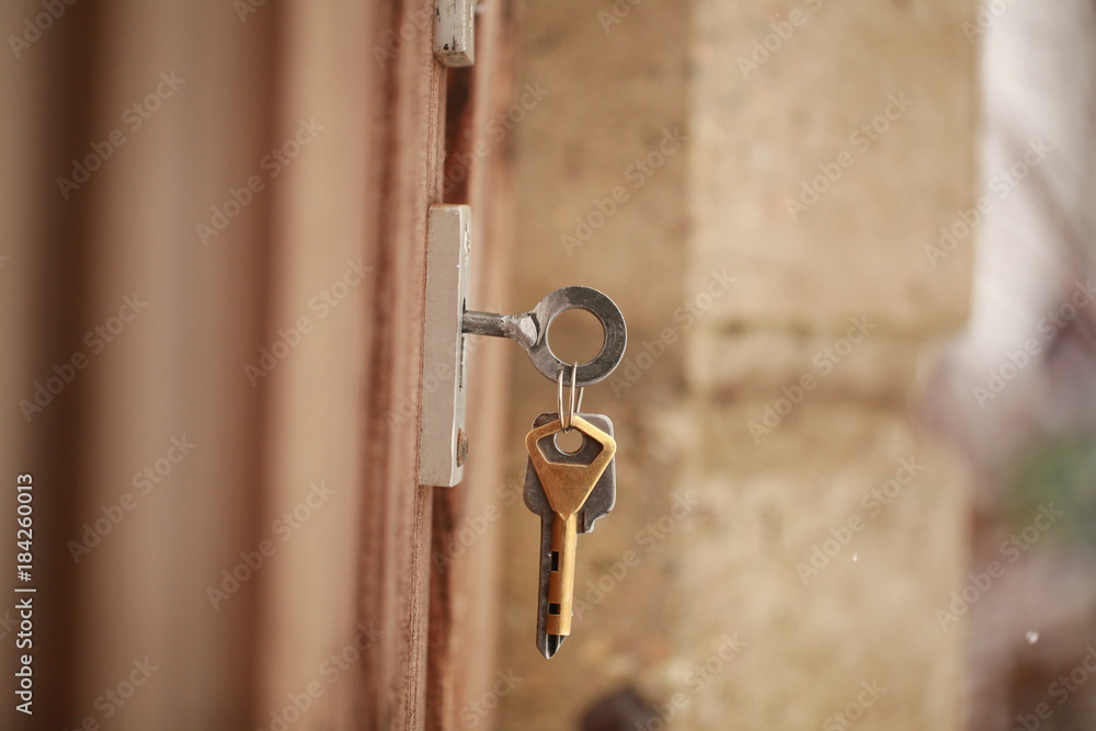 key in the lock of the wooden door