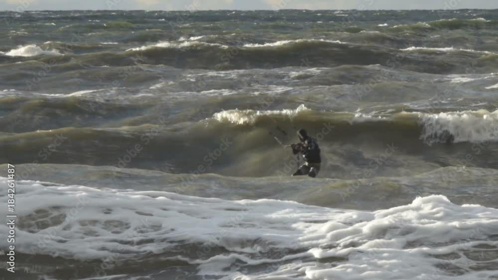 Kiteboarding, Fun in the ocean, Extreme Sport. Extreme Kitesurfing in stormy weather. Summer Ocean Sport in Slow Motion. Kiteboarding, Fun in the ocean, Extreme Sport. Extreme Kitesurfing in stormy weather. Summer Ocean Sport in Slow Motion.