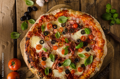 Rustic pizza with tomato, cheese, salami