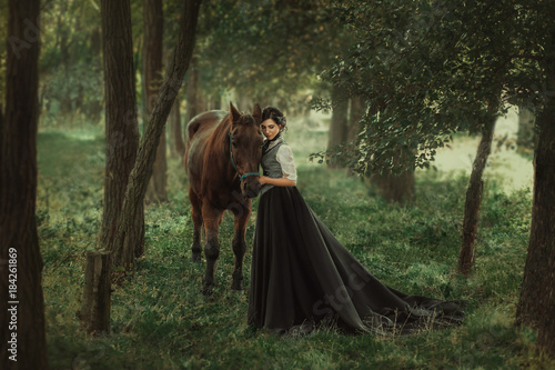 Gourmet lady in a vintage dress. A beautiful rider gently hugs the horse. Artistic Photography