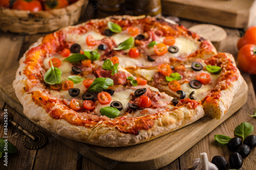 Rustic pizza with tomato, cheese, salami