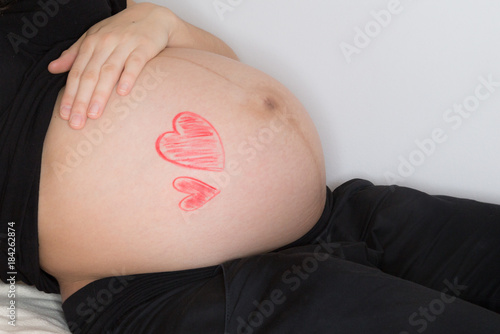 Close-up of a pregnant woman touching her belly
