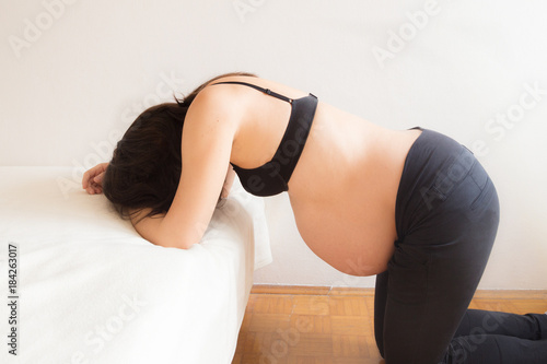 Pregnant woman having contractions in labour pain 