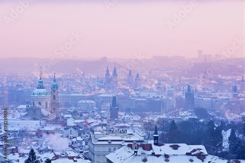 Winter Prague Panorama with Snowy Towers and Roofs