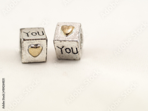 Obraz na plátne Silver cubes on a white background with a confession of love on St