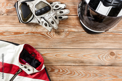 View of motorcycle rider accessories placed on rustic wooden table