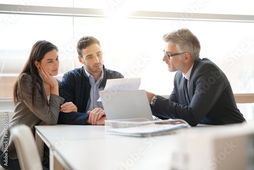 Young couple meeting financial advisor for home investment