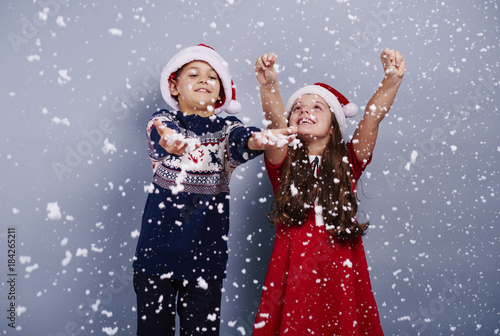 Happy children catching snowflake.
