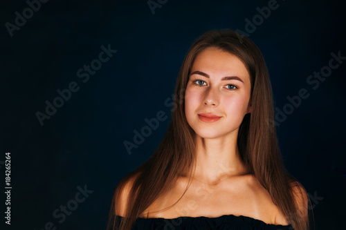 Portrait beautiful girl on a dark studio background