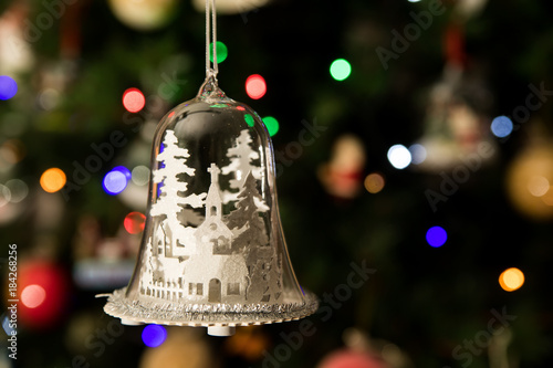 White church in glass bell shape ornament hanging on Christmas tree