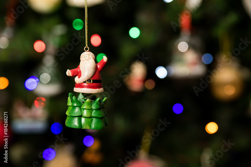 Santa over green tree ornament hanging on Christmas tree