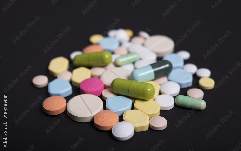 colorful medicine. Pharmacy on black background.