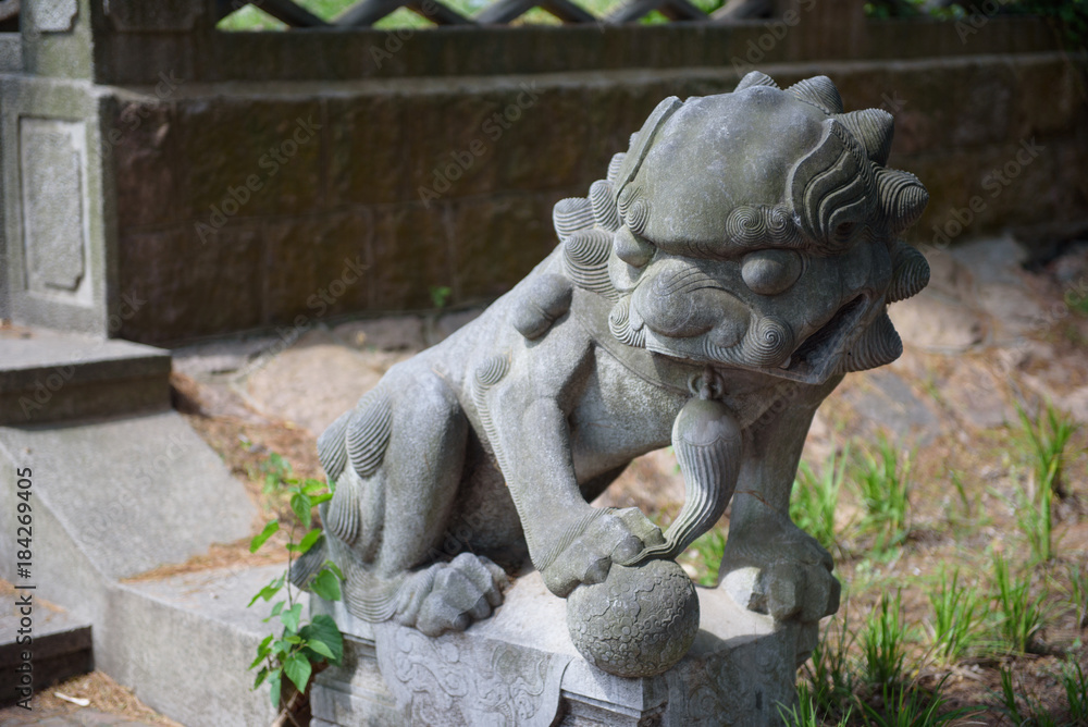 Chinese stone lion. The Chinese sculpture of a lion from a stone Chinese stone lion. The Chinese sculpture of a lion from a stone