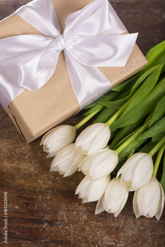 White tulips on wooden background