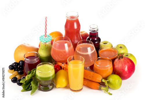 Glasses with fresh organic vegetable and fruit juices isolated on white.