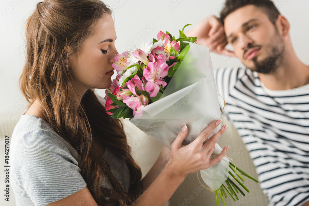 young woman with beautiful bouquet presented by boyfriend young woman with beautiful bouquet presented by boyfriend