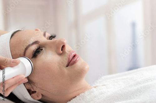 Woman in beauty spa have radio waves face lifting with laser