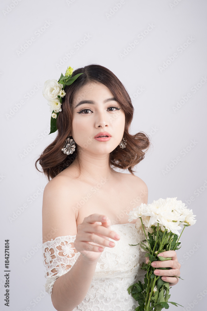 Beautiful asian woman bride on grey background. Closeup portraits with a professional makeup Beautiful asian woman bride on grey background. Closeup portraits with a professional makeup