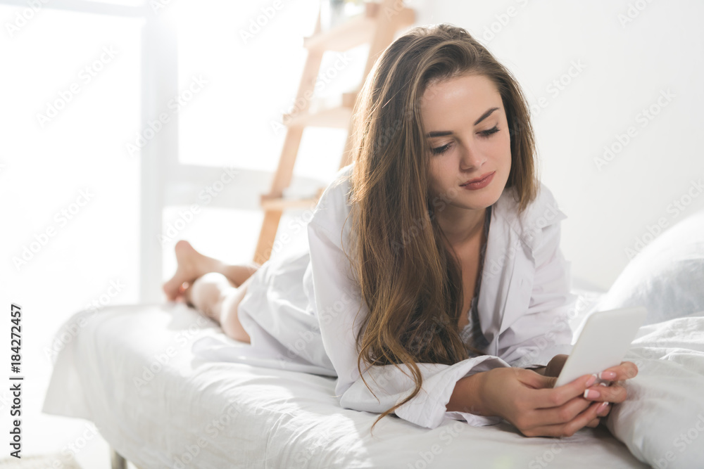 beautiful young woman using smartphone in morning beautiful young woman using smartphone in morning