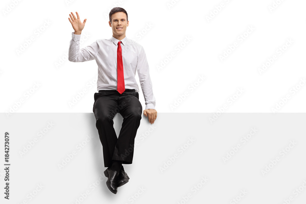 Formally dressed guy sitting on a panel and waving Formally dressed guy sitting on a panel and waving