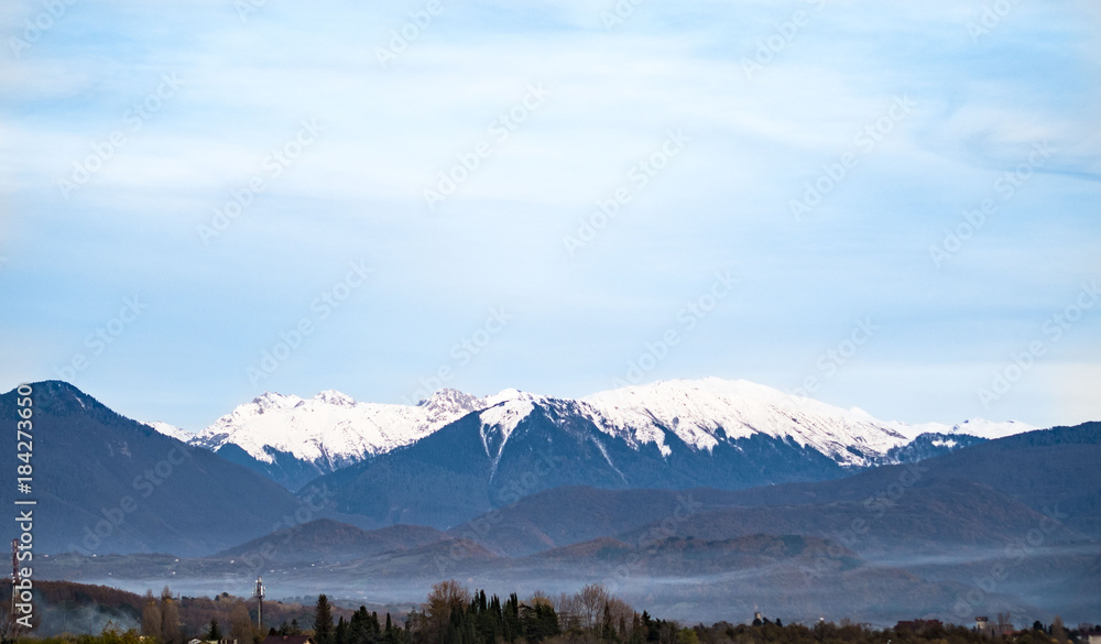  Fog in the mountains, snow-capped peaks, horizontal shot, landscape.