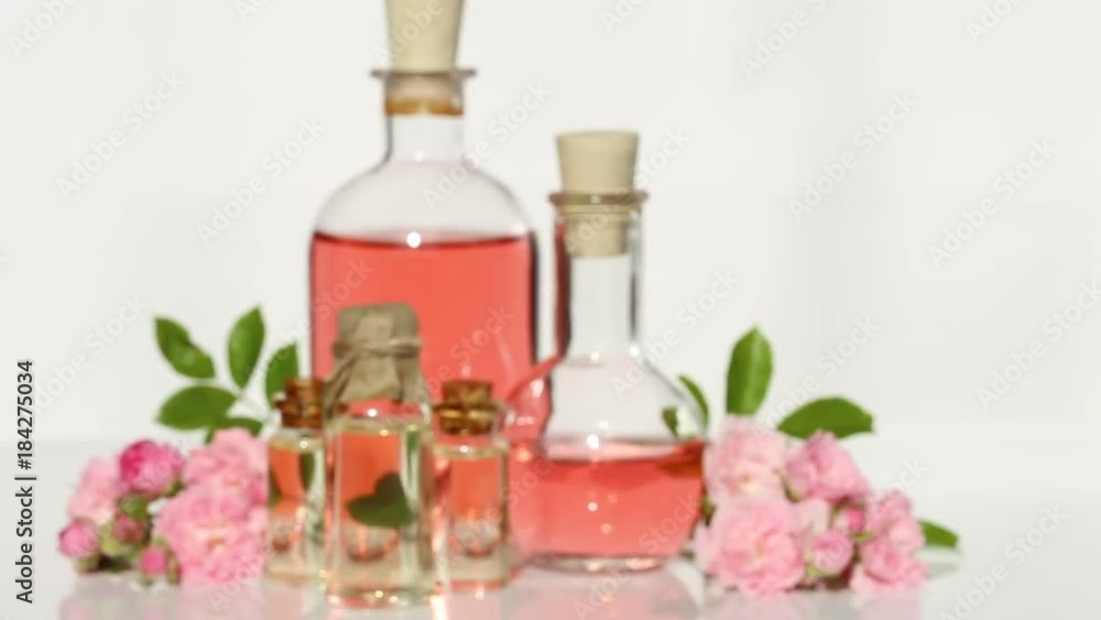 rose oil. Organic pure natural rose oil in a glass bottle and fresh flowers rose rose oil. Organic pure natural rose oil in a glass bottle and fresh flowers rose