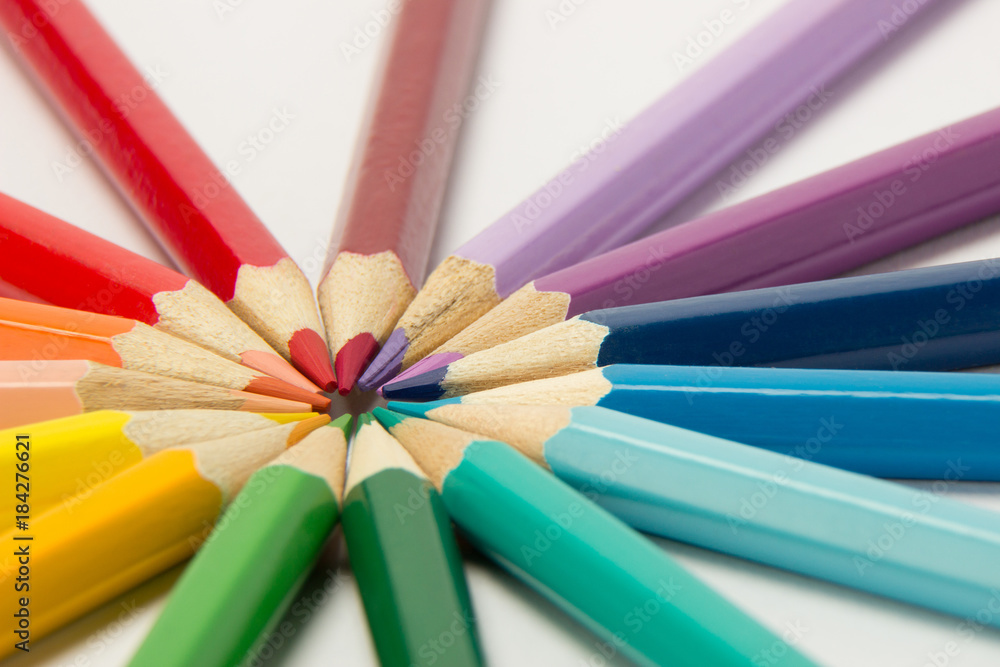 Naklejka premium A group of pencils folded in rainbow colors in a circle on a white background