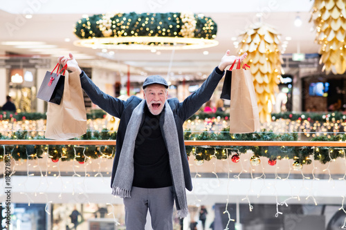 Senior man doing Christmas shopping.