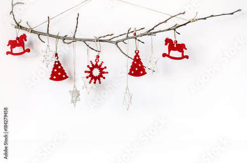 New Year's unusual composition with a branch and Christmas-tree toys. Christmas background for presentation of work or text. Beautiful greeting card. Copy space