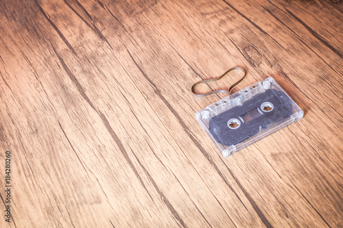 Wallpaper Mural vintage love songs concept . audio cassette tape are Heart shape on the wooden table .  Customise retro vintage style colors tone . Torontodigital.ca